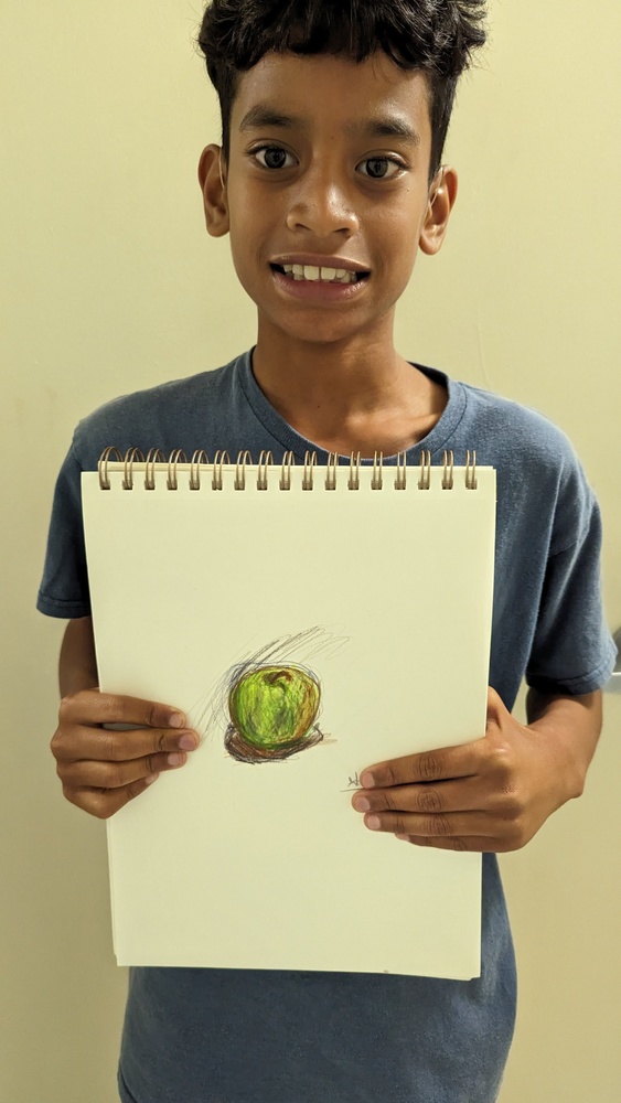 Student holding picture of an Apple