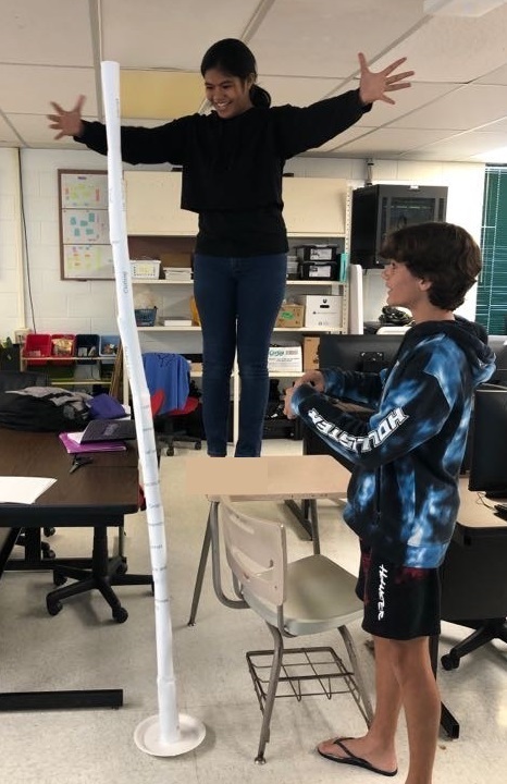 Students demonstrating paper tower building